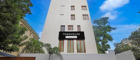 A building with a sign reading 'TOWNHOUSE' and a company-serviced logo.