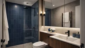 A modern bathroom with a glass shower enclosure, a toilet, a sink, and a large mirror. - Prime Central 2BR Apartment Covent Garden (London)
