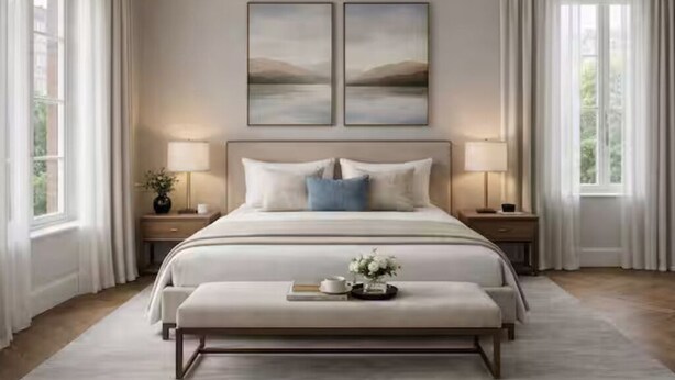 A bedroom with a large bed, two bedside tables, a bench, and two wall-mounted paintings. - Prime Central 2BR Apartment Covent Garden (London)