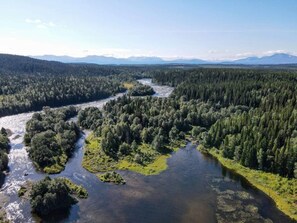 A river winding through a dense forest with mountains in the background. - 6 Person Holiday Home in Duved (Duved)
