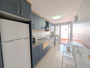 A kitchen with cabinets, a refrigerator, a microwave, and a sink. - 139 Livingtarifa Gonga House (Tarifa)