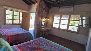 A room with two beds, a desk, and large windows. - SS 7A Cabaña rustica frente al malecón de La Paz (La Paz)