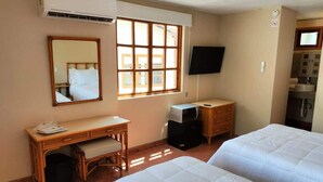A hotel room with two beds, a desk, a mirror, a television, and a window. - SS 3A Cabaña rustica frente al malecón de La Paz (La Paz)