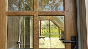A wooden door with a glass window, a door handle, and a keyhole. - The Loft – 1 bed space with gated parking (Binfield Heath)