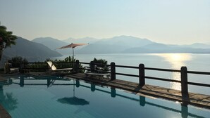A swimming pool with a view of mountains and a body of water. - Stunning Lake Maggiore Villa, pool and panoramic views, timeless Italian charm (Gonte)