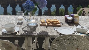 A table set for dining with a view of a lake and mountains. - Stunning Lake Maggiore Villa, pool and panoramic views, timeless Italian charm (Gonte)
