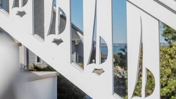 A white staircase with a railing that has cut-out letters spelling 'PARK.'