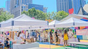 A cityscape with tall buildings and a market area with tents and people. - Modern Mins To "Atrium & Novant" Uptown Char Airport (Charlotte)