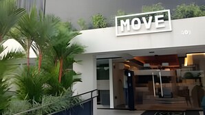 A modern building with a 'MOVE' sign, a glass entrance, and a balcony with plants. - Move Oásis Tambaú (Joao Pessoa)