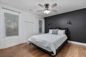 A bedroom with a bed, a ceiling fan, and a window with blinds. - Charming home near Clemson, SC! (Central)