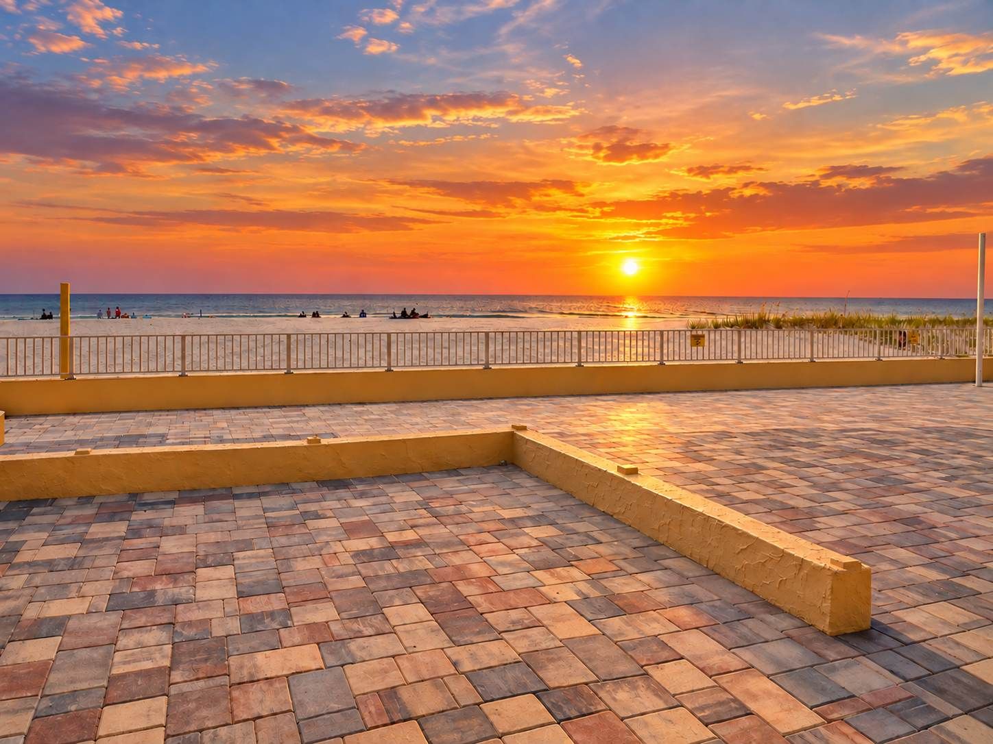 Una terrazza lastricata con vista sul tramonto sulla spiaggia.