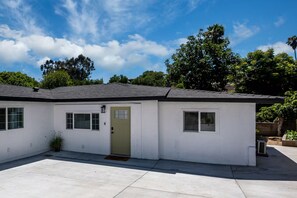 A single-story house with a front door, two windows, and a small porch area. - 3BR La Mesa Home w/Arcade, Parking Near SDSU (La Mesa)
