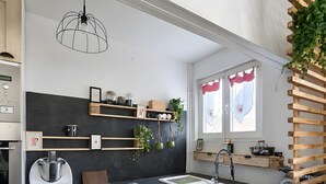 A modern kitchen with a dishwasher, a coffee machine, and a sink.