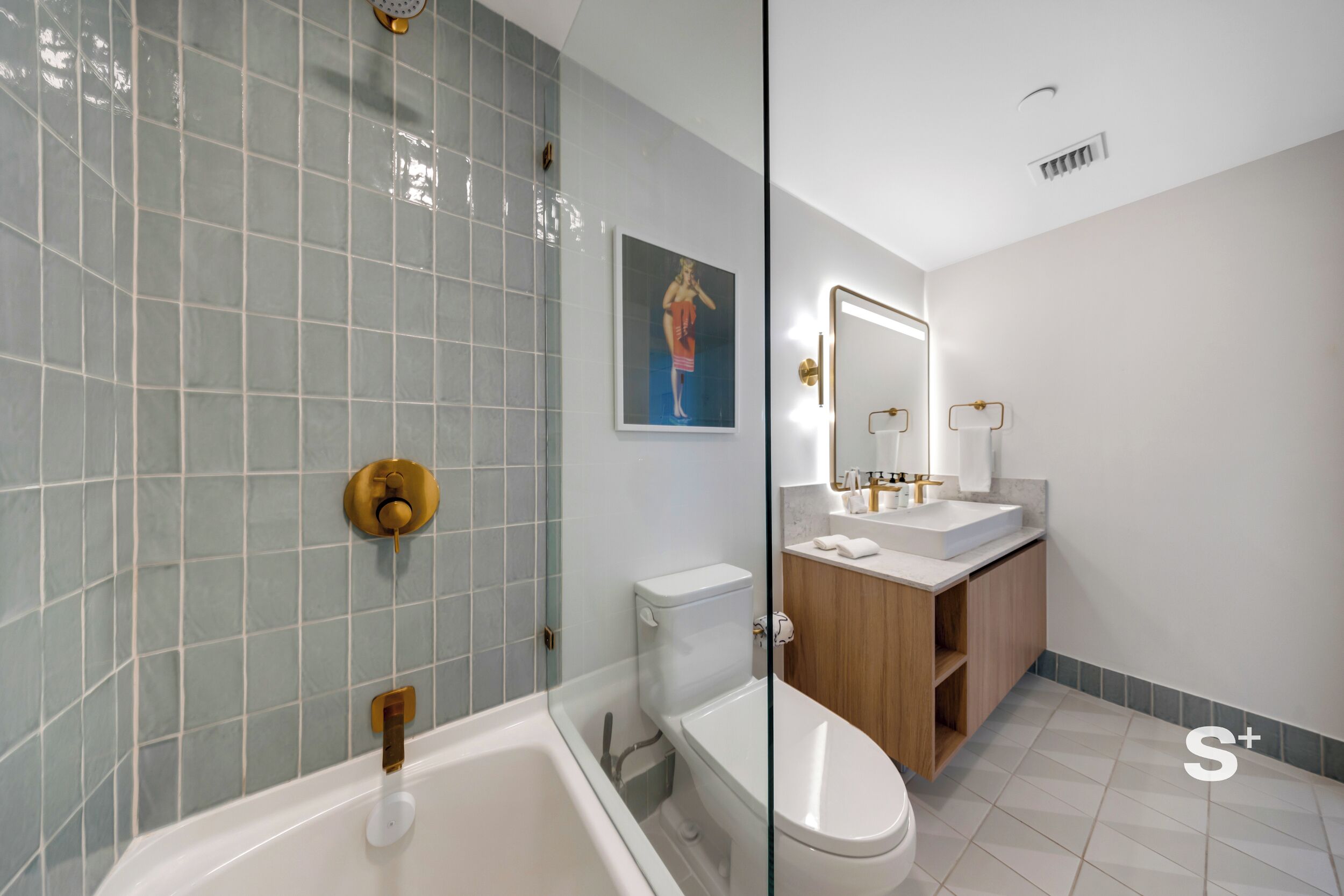 Un baño moderno con bañera, inodoro y tocador.