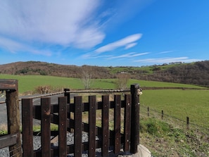 A rural landscape with a wooden fence and a clear blue sky. - Cennin Pedr (Ruthin)