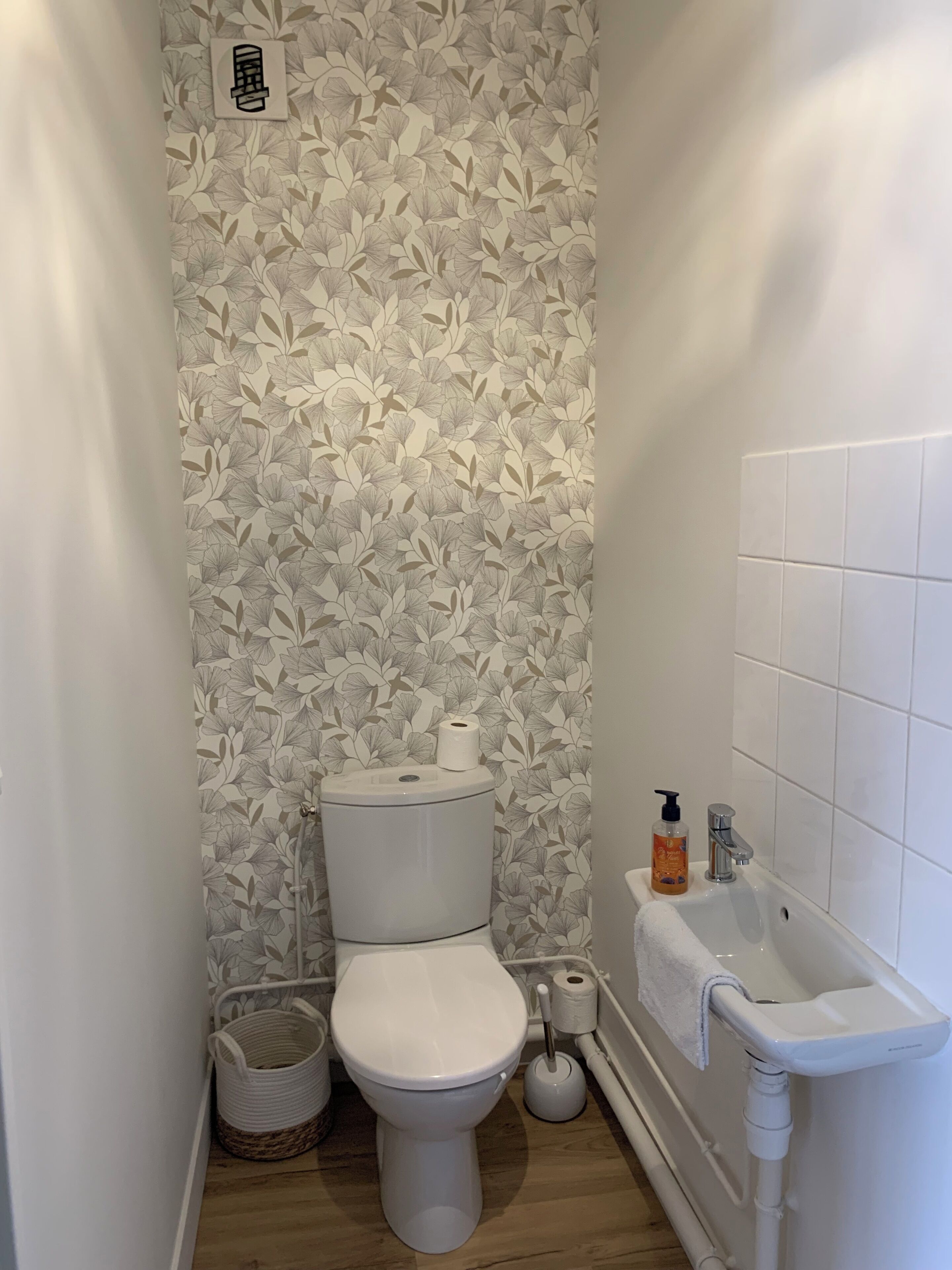A bathroom with a toilet, bidet, and sink.