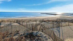 A beach with wooden fences and a clear sky.