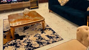 A living room with a TV, sofa, coffee table, and decorative items. - Vokz Luxury Shortlet (Alakahia)