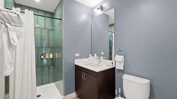 Shower, hair dryer, towels, shampoo