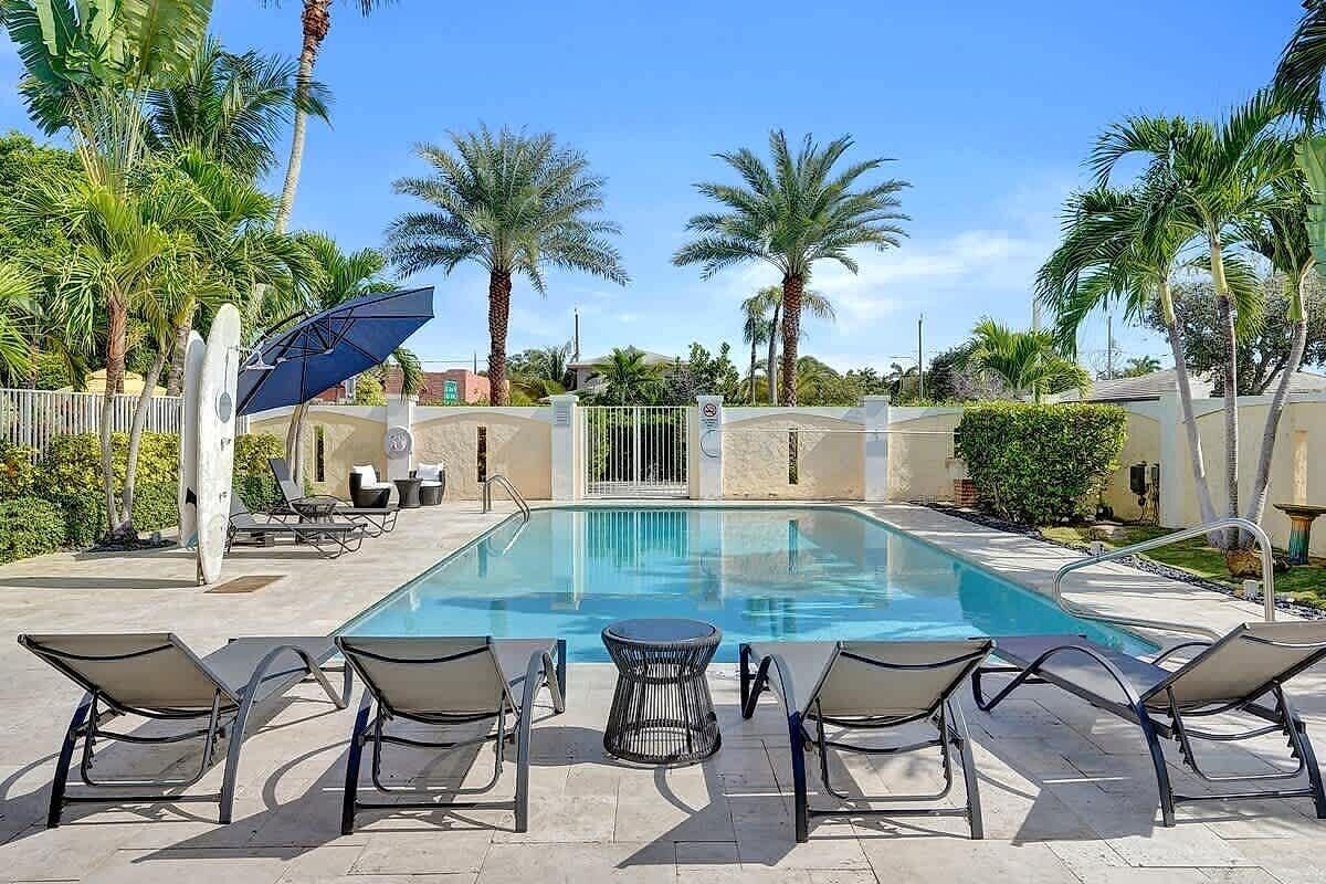 Resort pool with lounge chairs and tropical palms