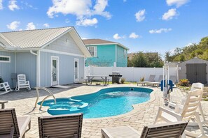 A backyard with a swimming pool, lounge chairs, a barbecue area, and a shed. - Duplex with Private Pool, Grill, Arcade and Backyard (Port St. Joe)