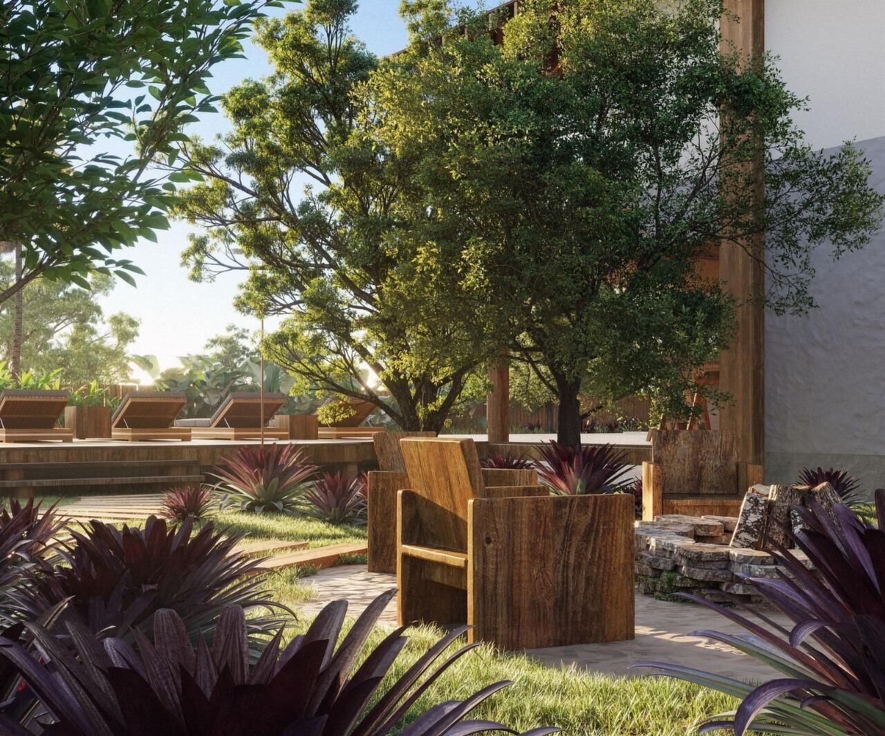 An outdoor seating area with wooden chairs and tables, surrounded by lush greenery and trees.