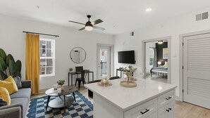A modern apartment with a living room, kitchen, and bedroom. - The Lofts On Maney (Murfreesboro)