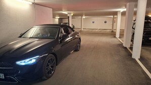 A parking garage with a dark-colored car parked in a spot marked with a 'P'. - Ski-in/Ski-out directly next to the gondola – KitzSki (Mittersill)