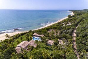 A resort with a swimming pool, beach access, and lush greenery. - Sophisticated retreat in Itapororoca, Trancoso, with 6 bedrooms and ocean views. (Trancoso)