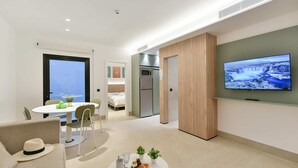 A modern hotel room with a dining area, a TV, a bed, and a kitchenette. - 1 bedroom interior apartment (Las Palmas de Gran Canaria)