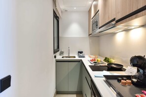 A compact kitchen with a sink, stove, and microwave. - Double with balcony and sea view (Las Palmas de Gran Canaria)