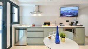 A modern kitchen with a built-in oven, a microwave, a sink, and a flat-screen TV mounted on the wall. - Top Floor Penthouse Studio (Las Palmas de Gran Canaria)