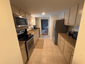 A kitchen with a microwave, stove, refrigerator, and toaster. - THE RIVERSIDE RETREAT - 30 minutes from SAVANNAH GA- FLOAT/BOAT/RINSE/REPEAT (Midway)