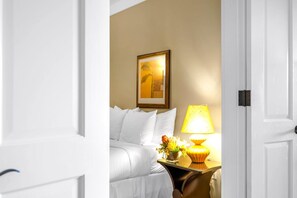 A hotel room with a bed, a bedside table with a lamp, and a framed picture on the wall. - Honua Kai 4 Free Rental Cars KBM Resorts Gorgeous Inner Courtyard 4 Units, 7 Bedrooms HK Ml-2731 (Kaanapali)