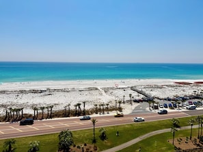 A coastal road with a beach and ocean in the background.