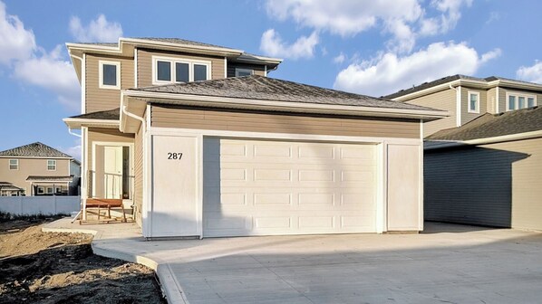 A two-story residential building with a garage numbered 287.