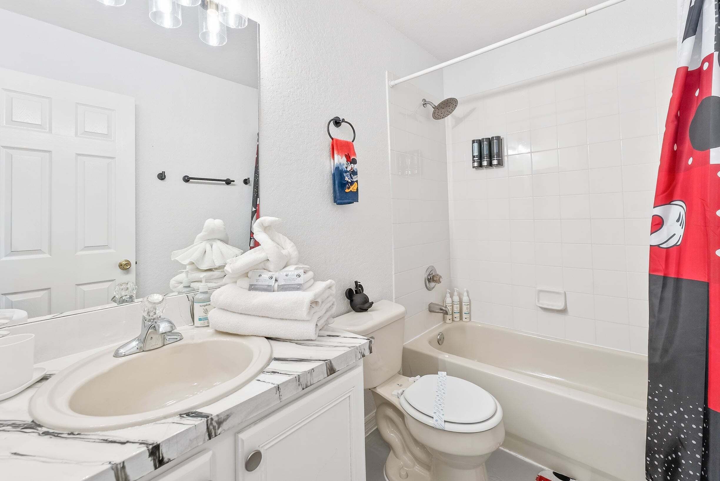 A bathroom with a sink, toilet, bathtub, and a shower.