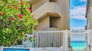 A gated entrance to a private beach villa complex with a sign indicating 'Private Beach Access' and 'Miramar Beach Villas.' - 3BR, 3BA, Villa steps from sand with private beach access, beach gear & pool! (Miramar Beach)