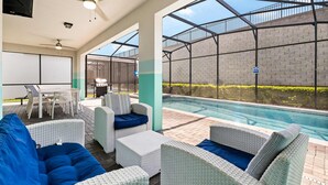 A poolside area with wicker furniture, a table, and a grill. - Upstay Disney Family Adventure with Pool & Hot Tub (Davenport)