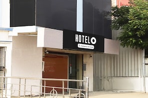 A hotel sign with 'HOTEL' and 'Company-Serviced' text.
