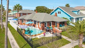 A residential area with houses, a swimming pool, and a fenced yard. - Charmed Lagoon (Galveston)