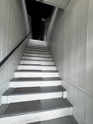 A staircase with white walls and dark steps leading upwards. - Historic Downtown Loft in Cartersville (Cartersville)