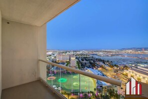 A balcony with a city view, including a golf course and buildings. - Vegas Strip 1BR Condo | Balcony + No Resort Fee (Las Vegas)