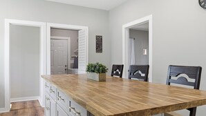 A kitchen with a wooden countertop, white cabinets, and a potted plant. - New Listing! The Landing Pad - 8 minutes to ATL Airport! (Atlanta)