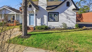 A single-story house with a gabled roof, a chimney, and a front porch. - New Listing! The Landing Pad - 8 minutes to ATL Airport! (Atlanta)