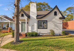 A single-story house with a gabled roof, a chimney, and a front porch. - The Runway Retreat - 8 minutes to ATL Airport! (Atlanta)