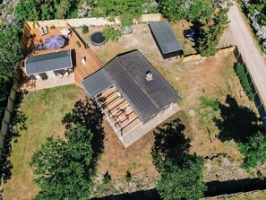 An aerial view of a residential property with a large deck, a swimming pool, and a covered patio area. - Lovely holiday home for the whole family (Vig)