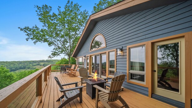 A deck with outdoor furniture, a fire feature, and large windows. - Daisy Ridge - Expansive Mountain View, Pets OK, Beech Mtn Club option, foosball, arcade (Beech Mountain)