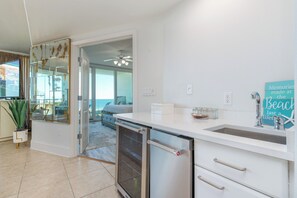 A modern kitchen with a built-in oven, a small refrigerator, and a sink. - Chic Three Bedroom Condo with Beautiful Gulf Views! Complimentary Boat Slip! (Orange Beach)