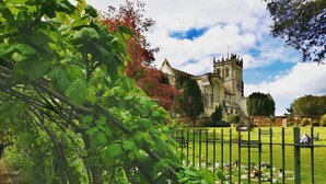 A historic church with a prominent tower, surrounded by a well-maintained cemetery and lush greenery. - Modern town house situated in a quiet location with views across the harbour (Christchurch)